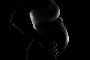 gray-scale-photo-of-a-pregnant-woman-